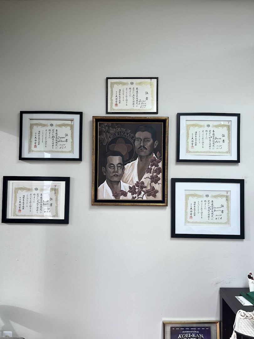 Framed certificates and Koei-Kan artwork displayed on the dojo wall