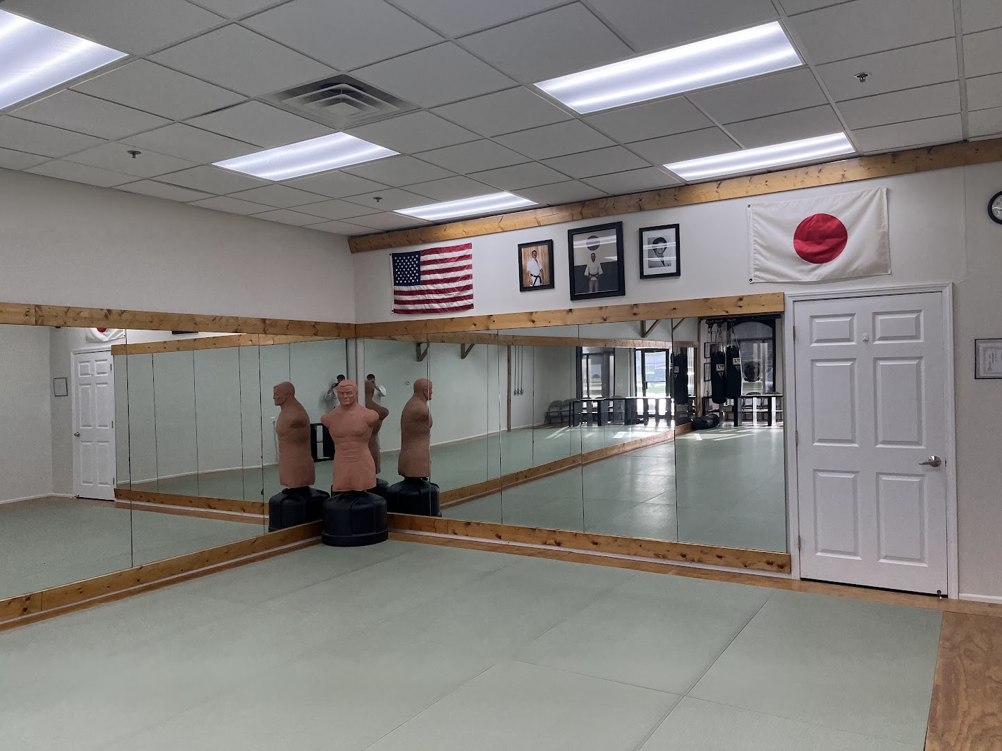 Matted training floor and mirrored walls inside the Shelby Township dojo